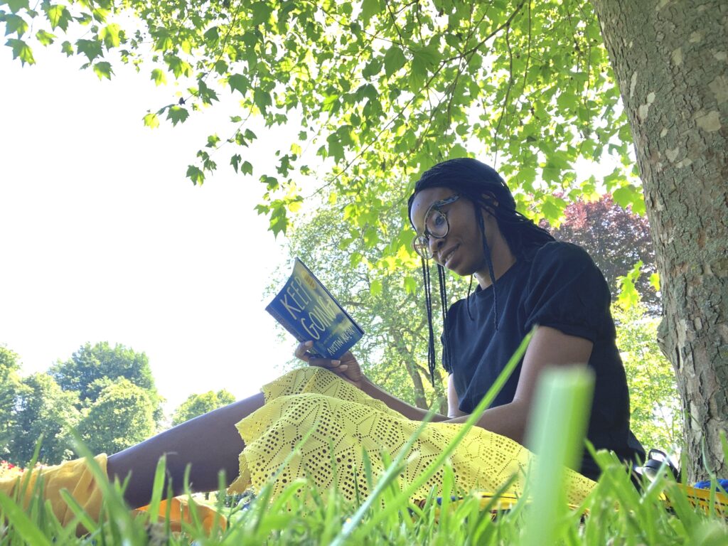 Girl reading a book under a tree